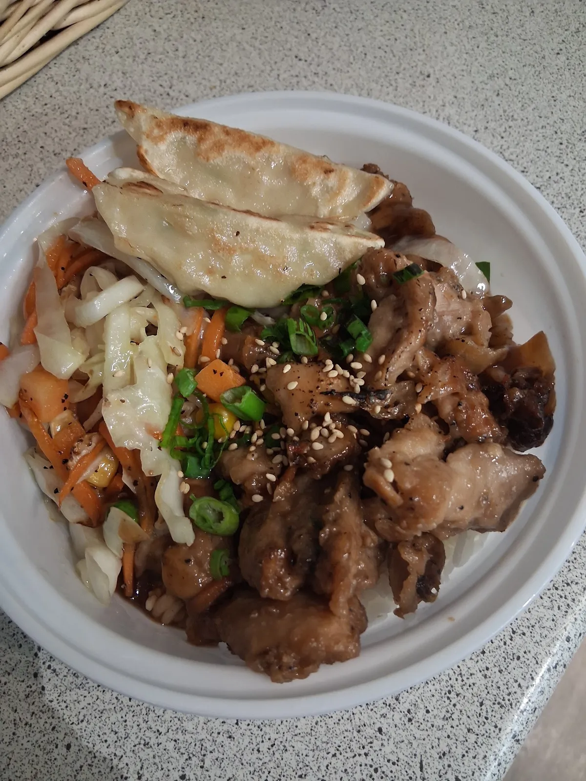 Chicken teriyaki bowl with gyoza and cabbage salad