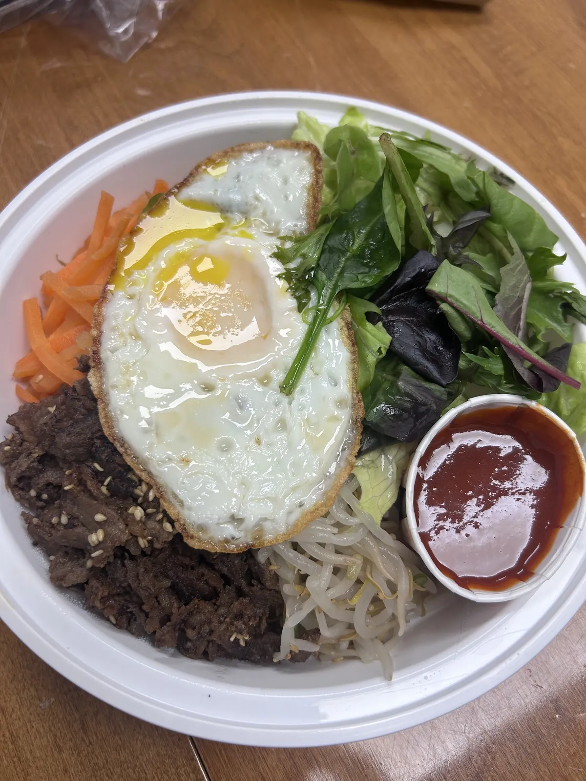 Bibimbap bowl with fried egg, beef, and vegetables